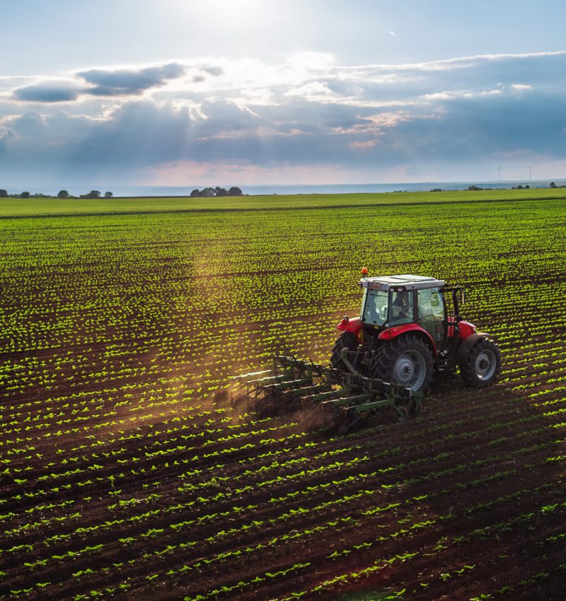 Tractor cultivating field at spring,aerial view